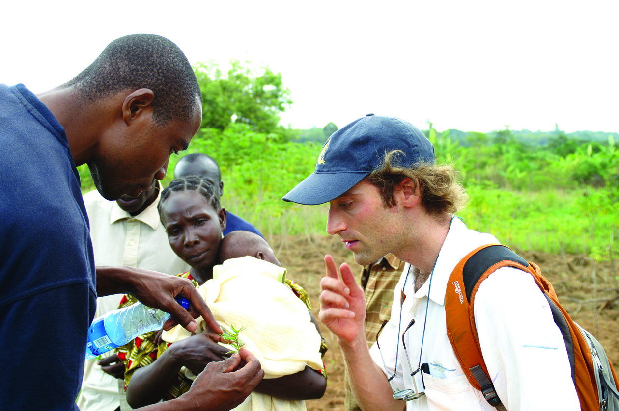 “It was a really positive experience for me as a graduate student because I was surprised at how useful my expertise as a soil scientist actually could be,” said Michael Wolff, seen here, a UC Davis graduate student who went to Kenya through last year’s Trellis projects. Students from four universities will participate in the new round of Trellis projects, beginning in September. Horticulture CRSP photo, courtesy of Michael Wolff. staff member shows student plant detail with farmer in background, in kenya