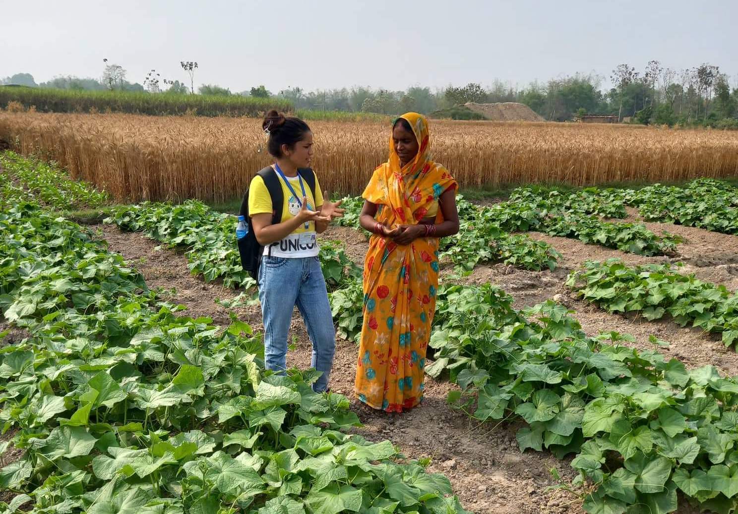 researcher with woman farmer in field