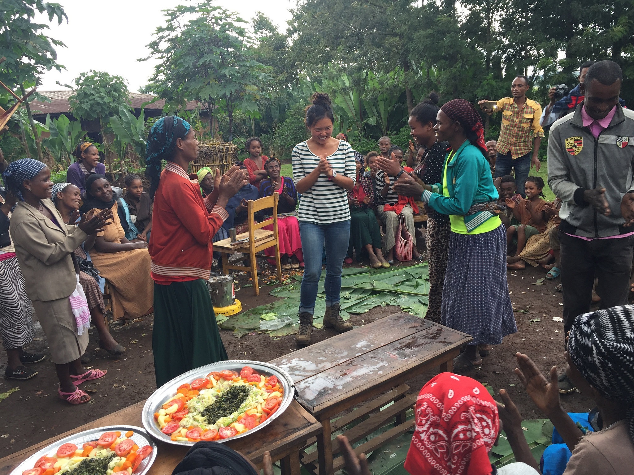 Lauren Howe pictured with smallholder farmers during her sweet potato leaves taste test