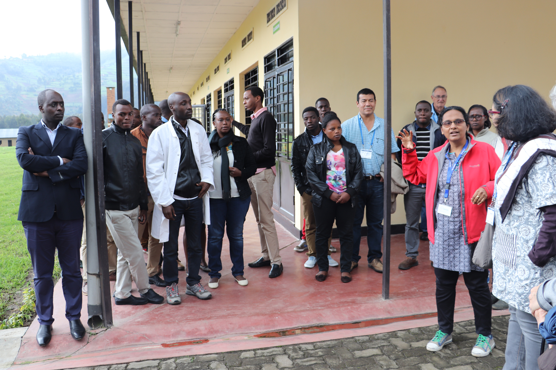 Woman scientist speaking to a group outside in Rwanda