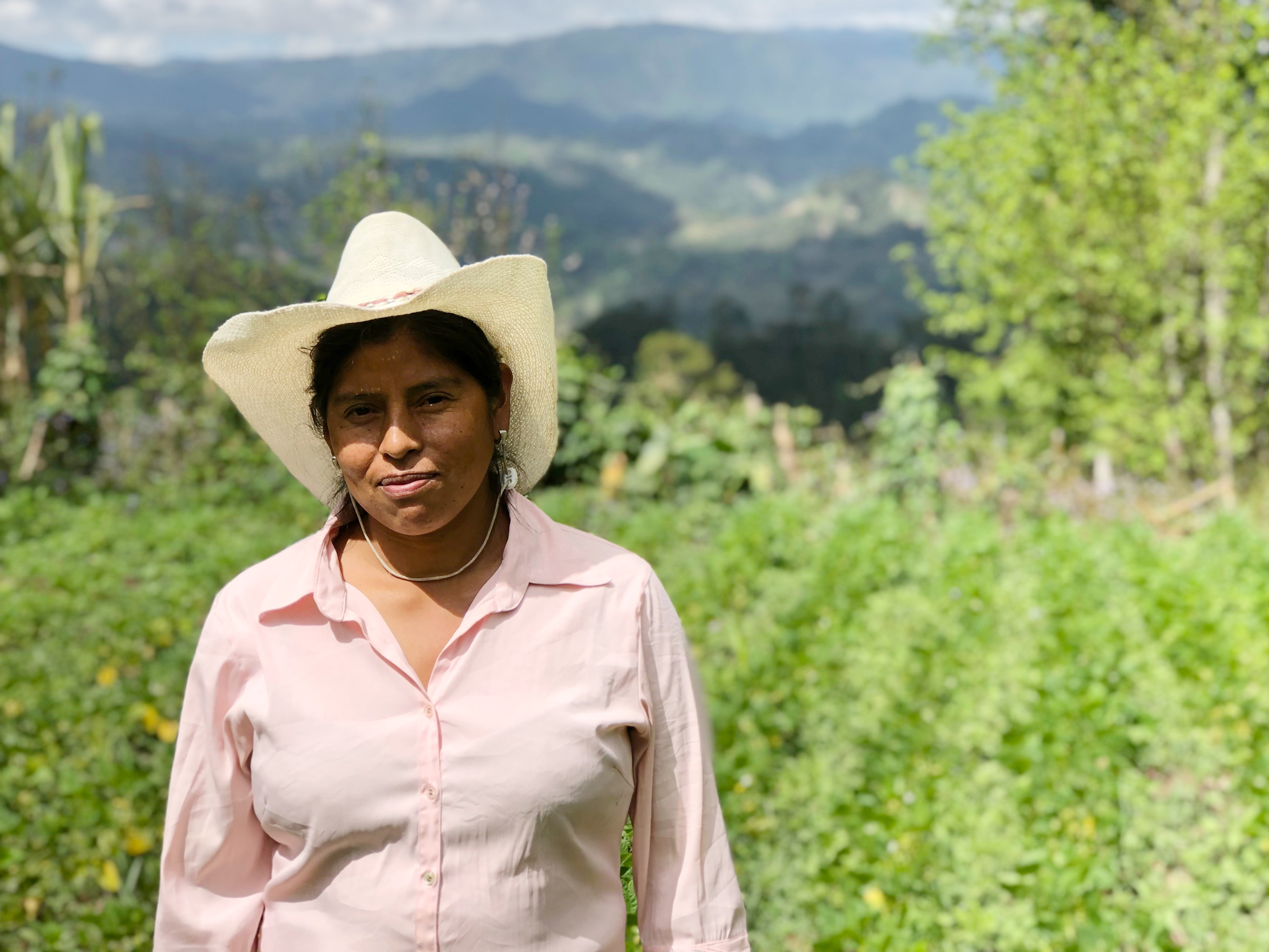 Woman in cowboy hat in a farm field in Honduras highlands