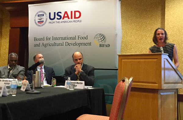 Student accepts award with BIFAD board at meeting of the Board for International Food and Agricultural Development