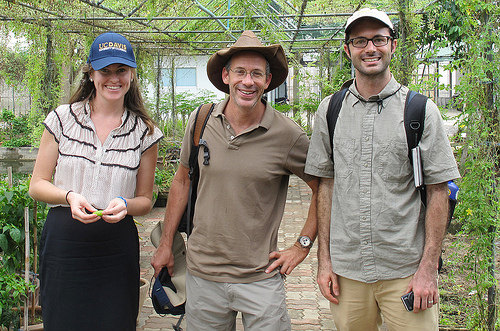 three researchers in greenhouse with backpacks and UC Davis hat