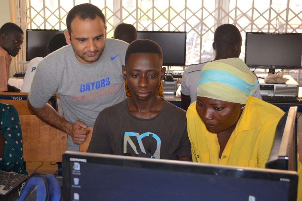 trainer with students at computer