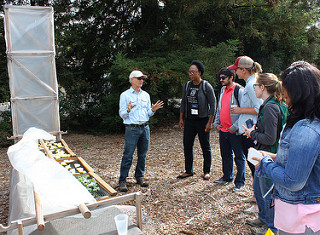 Group with chimney solar dryer demonstration with pineapple and kale IMG_4878eds