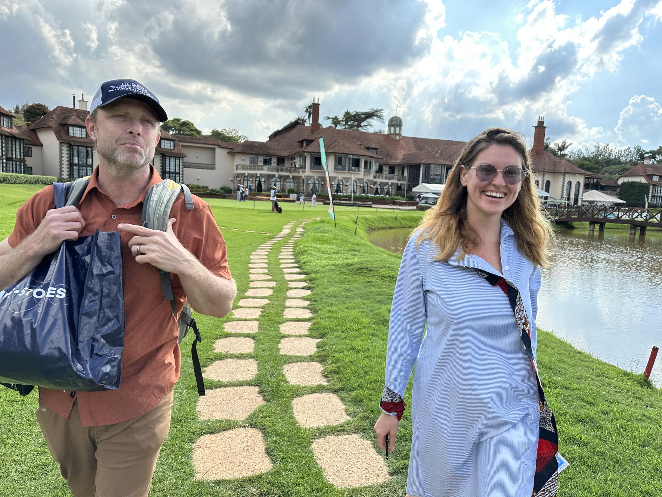 Two individuals walking together towards camera