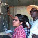 Women scientists discuss CoolBot, air conditioner, and cold storage insulation at UC Davis student farm.