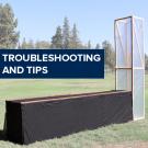 "Troubleshooting and tips" on a photo of the chimney solar dryer in a sunny field
