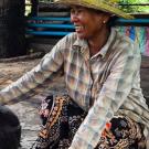 Cambodian pig farmer with sow